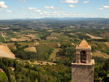 Scenic view of landscape and buildings against sky