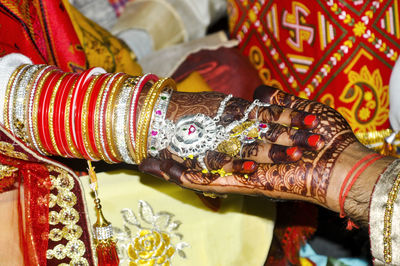 High angle view of bride and groom holding hands during wedding ceremony