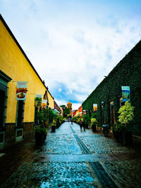 Road amidst city against sky