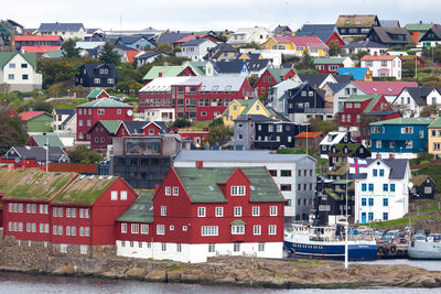High angle view of houses by river in city