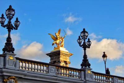 Low angle view of statue against cloudy sky