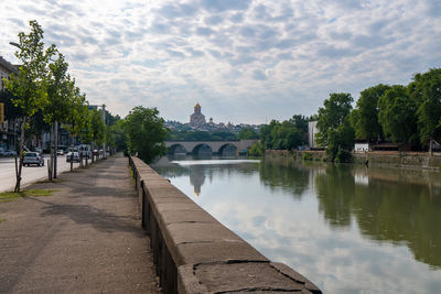 Panoramic view of river amidst buildings against sky