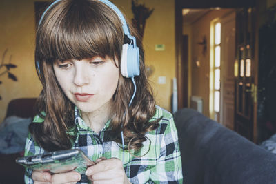 Portrait of young woman using mobile phone