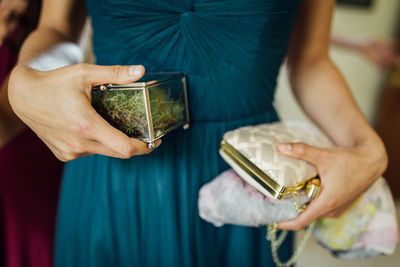 Midsection of woman holding purse 