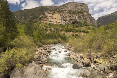 Scenic view of waterfall against sky