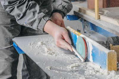 Midsection of man working at workshop