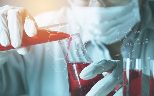 Digital composite image of man examining chemical in laboratory