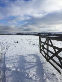 Scenic view of field against sky during winter