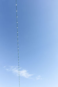 Low angle view of pole against blue sky