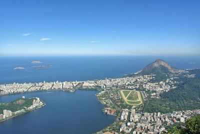 High angle view of sea and city against sky