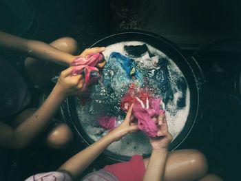 Midsection of women washing clothes at home