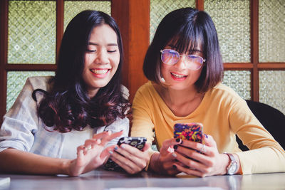 Happy young woman using smart phone