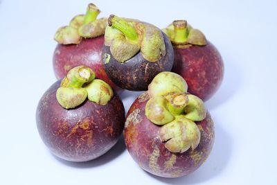 Close-up of fruit over white background