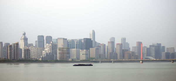 Modern buildings in city against clear sky