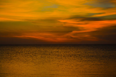 Scenic view of sea against orange sky