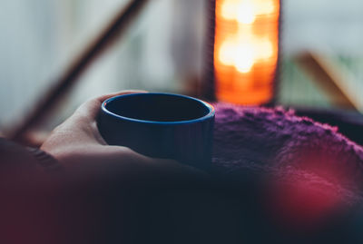 Close-up of hand holding coffee cup