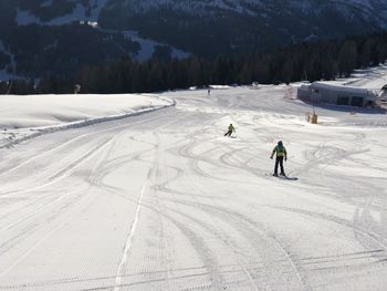 People skiing on snow covered mountain