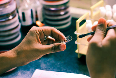 Close-up of person hands experimenting in laboratory