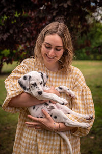 Young woman with a dalmatian puppy