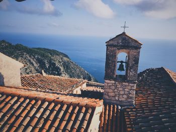 High angle view of old bell tower against sea