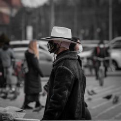 Rear view of man standing in city