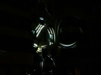 Close-up of illuminated lighting equipment against black background