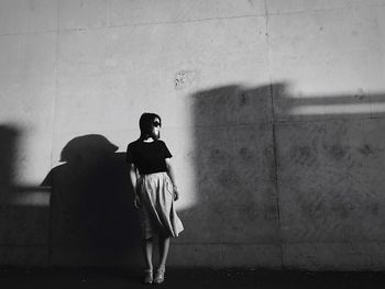 Rear view of child standing on floor