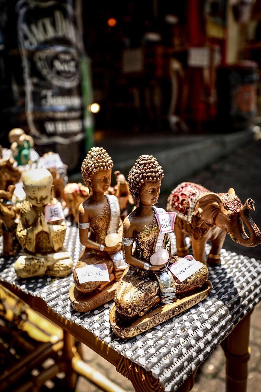 CLOSE-UP OF STATUE ON TABLE