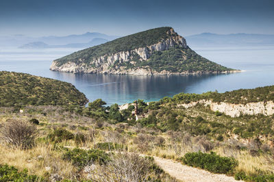 Scenic view of sea and mountains against sky