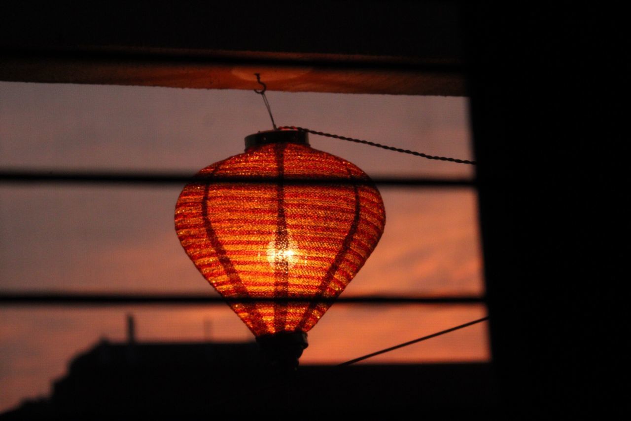 LOW ANGLE VIEW OF ILLUMINATED LIGHT BULB AGAINST SKY