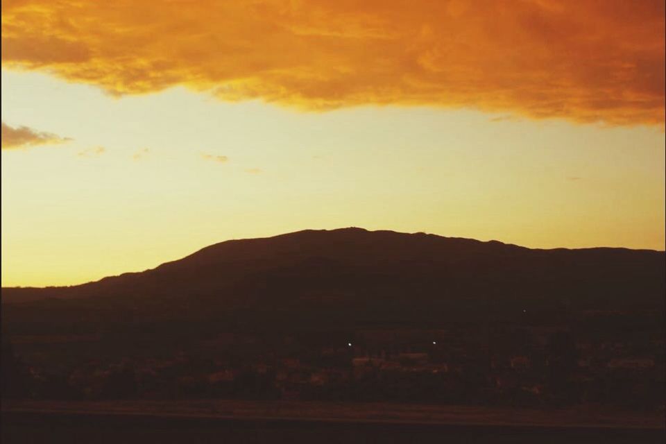 sunset, mountain, silhouette, scenics, tranquil scene, sky, landscape, tranquility, beauty in nature, mountain range, nature, orange color, dusk, idyllic, non-urban scene, cloud - sky, dark, outdoors, remote, no people