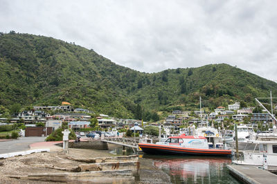 Boats moored in lake against sky