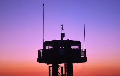 Low angle view of silhouette tower against sky during sunset