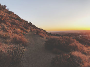 Scenic view of landscape against clear sky during sunset