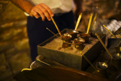 Midsection of man preparing food