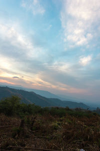 Scenic view of mountains against cloudy sky