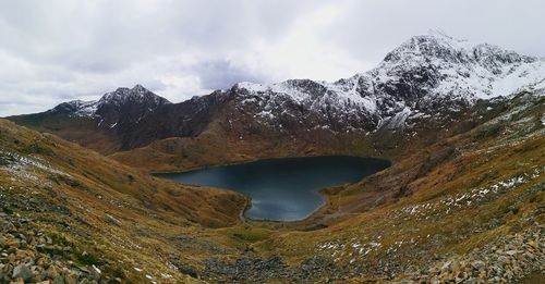 Scenic view of lake and snowcapped mountains against sky