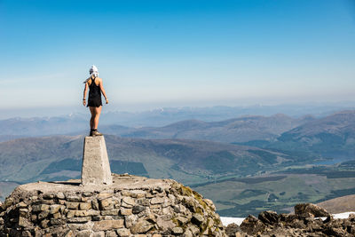 A middle aged female hiker on the top of ben nevis peak, fort william, scotland