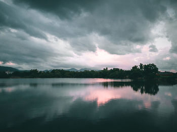 Scenic view of lake against sky at dusk