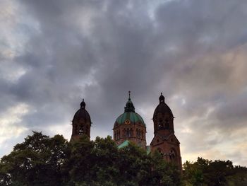 Low angle view of church against cloudy sky