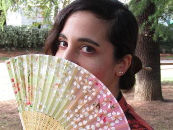 Portrait of beautiful woman against trees