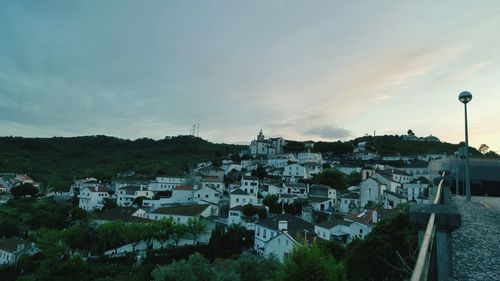 View of town against cloudy sky