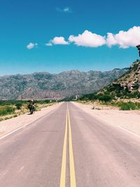 Road by landscape against sky