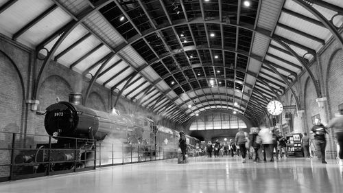 People walking in illuminated railroad station