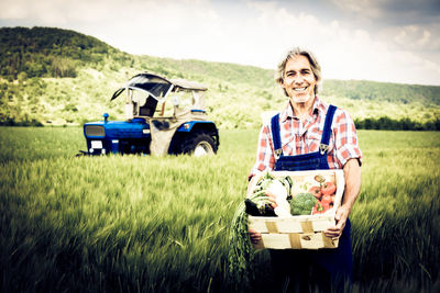 Portrait of smiling woman standing in farm