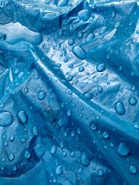 Full frame shot of blue canvas with raindrops