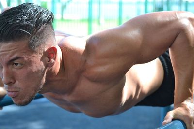 Muscular man exercising outdoors