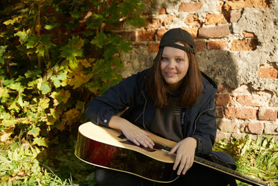 Portrait of young man playing guitar