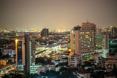 High angle view of illuminated buildings in city against sky