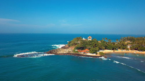 Scenic view of sea against blue sky